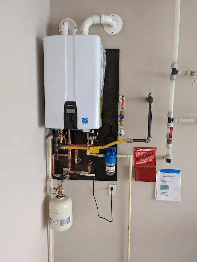 Professional plumber installing copper piping in a Lancaster home